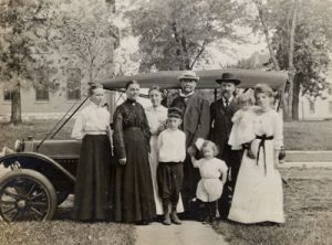 historical photo from Augsburg's archives of founders and family in front of a car