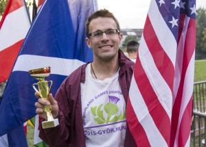Tom Dahlin holding trophy and American flag