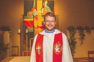 Micheal Buller wearing a red stole following his ordination