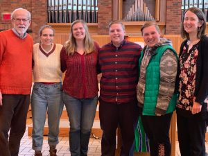 Group of students and staff in the chapel, Marty Wyatt is in the middle