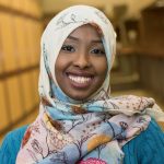 Portraits East Scholars in library