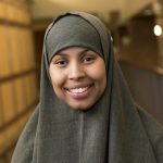 Portraits East Scholars in library