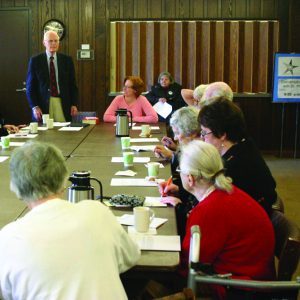 Phil Quanbeck speaks to a table of church members