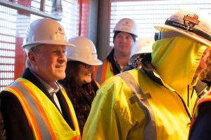 Schwarts and others wear safety vests and hard hats 