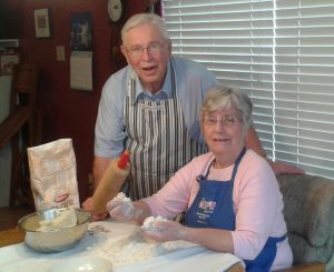 The Egertsons in their home making lefse