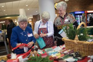 Three ladies browsing the items for sale.