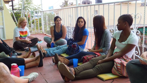 Students sitting outside along balcony