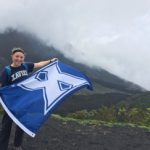 Girl with Xavier University flag at volcano