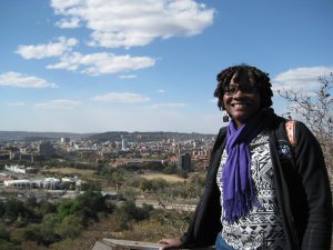 young woman in front of Pretoria skyline 