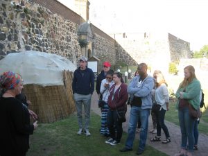 group of students listening to lecture outside