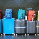 five rolling suitcases in a row