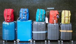 five rolling suitcases in a row