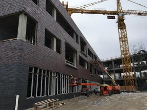 Installation of window panes continues on the ground-level window of the north wing. 