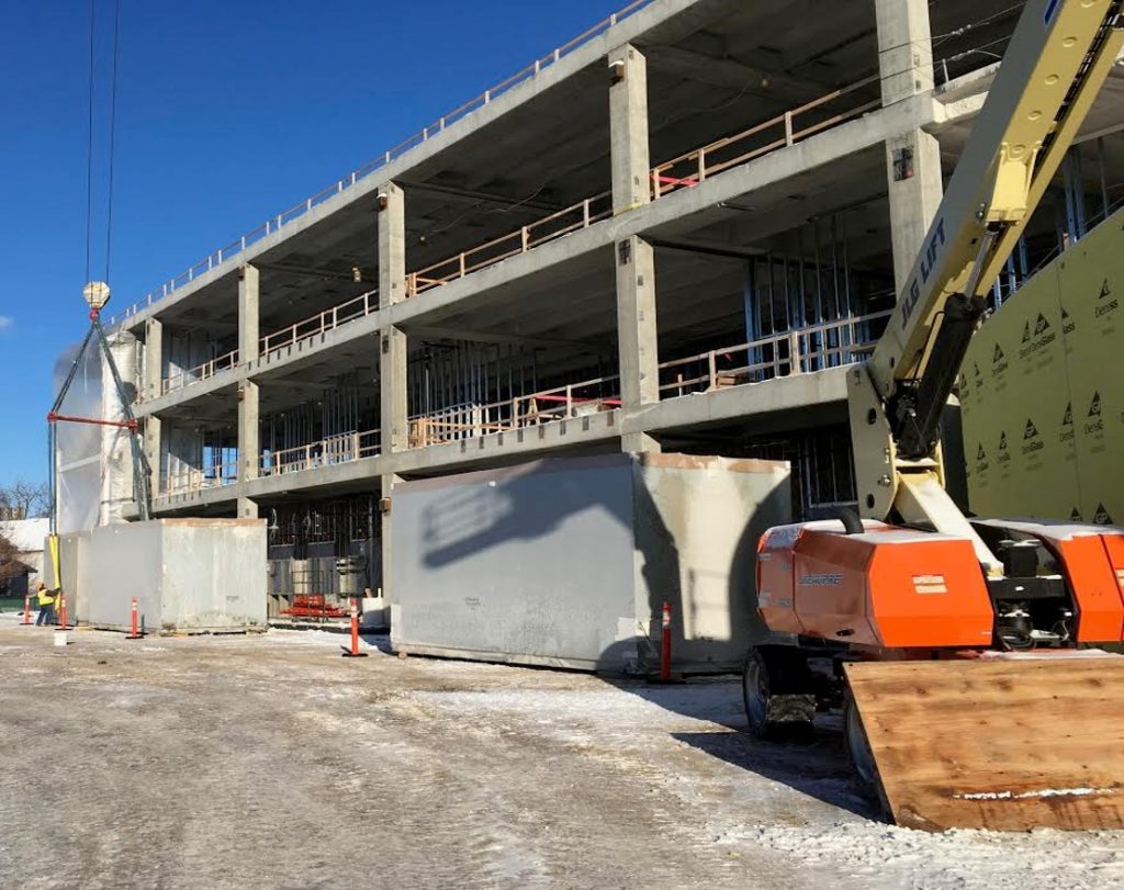 The building's two heating, ventilation and air-conditioning units were installed last week in the mechanical area on the fourth-level rooftop of the north wing.