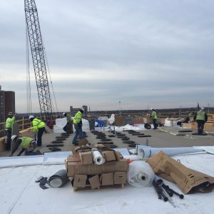 Installation of the white, reflective roof is underway, weather permitting.