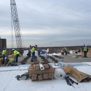 Installation of the white, reflective roof is underway, weather permitting.