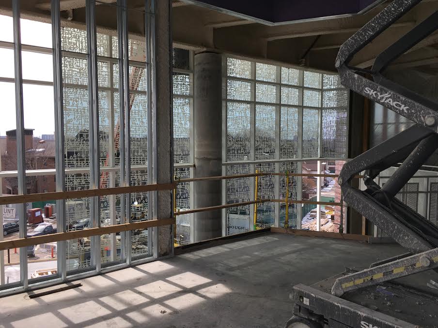 The installation of the window fritting on the 3-story lobby curtainwall is visible from the Gundale Chapel interior.