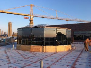 This rooftop view of the chapel cupola shows the completed glass installation and the tower crane before it was retired from the construction site.