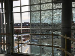 The lobby curtainwall glass fritting features Martin Luther's handwritten score of "A Mighty Fortress Is Our God" overlaid with the cell structure of elm wood.