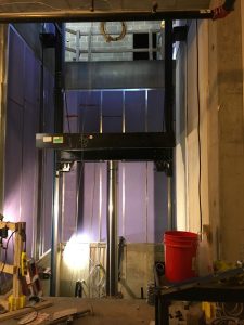 Installation of the hydraulic system on the north elevator is in progress.