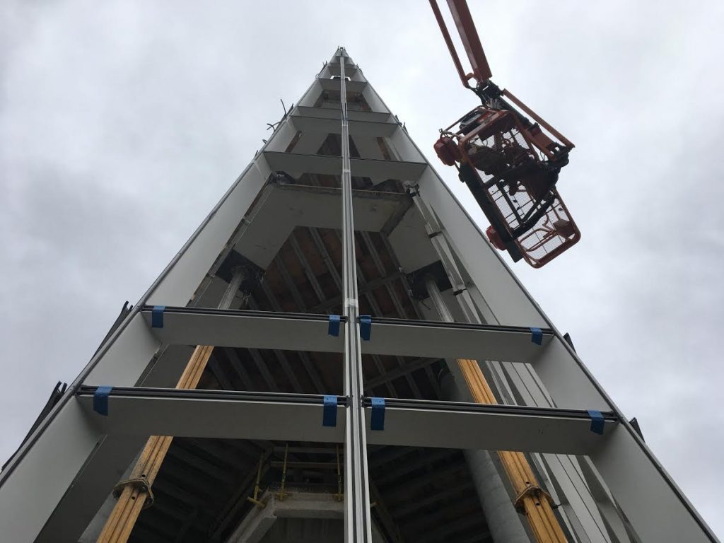 Glass installation continues on the exterior of the three-story lobby.