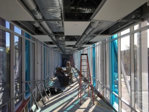 Skyway with ceiling installation in progress.