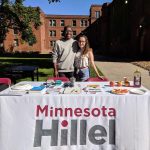 students at an outdoor Minnesota Hillel booth