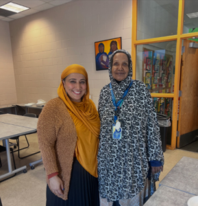 Two Muslim women pose, smiling