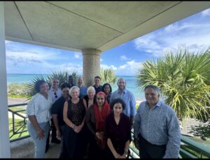 Interfaith leaders post for a group photo in front of the ocean