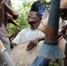 Haitian man plays a drum