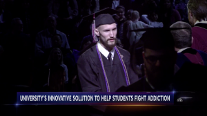 Neil King walking across the stage on Commencement day