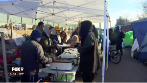 Augsburg University students serving lunch to homeless families.