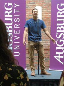 Augsburg student Elan Quezada speaking at the Climate Strike rally in the Oren Gateway Center