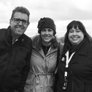 Hans Wiersma, Lori Brandt Hale, and Katie Code smile for a photo on their last alumni trip together