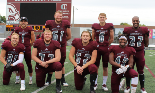 Four sets of brothers pose for a photo after a game