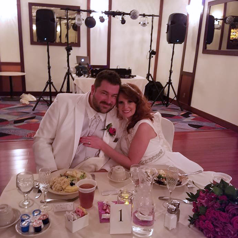 Annika and her husband posing for a photo at their wedding