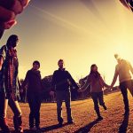 people holding hands in a circle