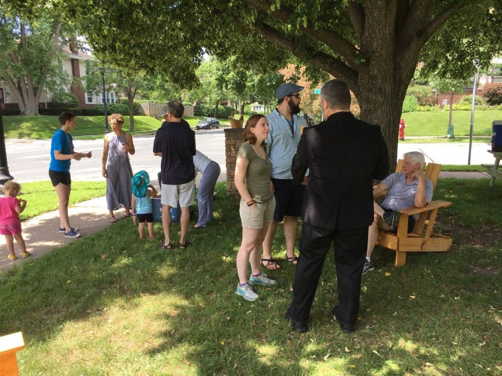 people talk in groups outside