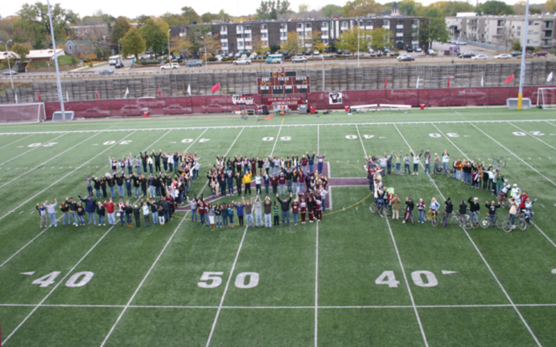 Augsburg community members form the number 350 on the football field