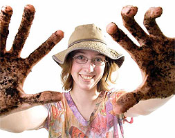 Augsburg student poses with dirt on her hands