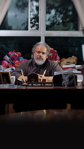 Bill Green sits at his desk