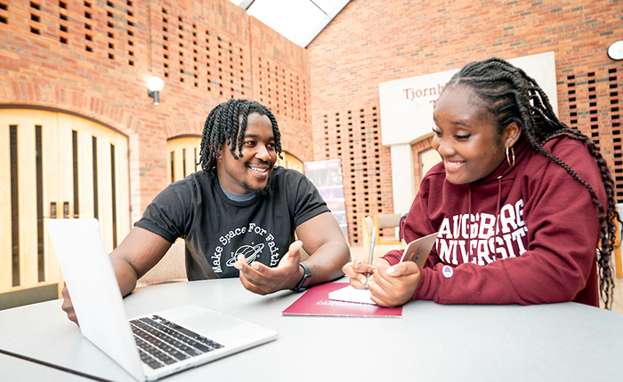 Two students talking to each other in Foss Center at Augsburg University