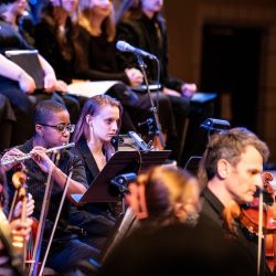 A student playing the flute at Advent Vespers