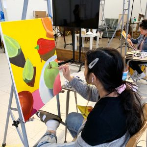 Studnet painting still life of fruit and vegetables