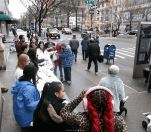 Students serve hot meals assembled into individual bags on the streets of New York City duing their Campus Ministry Alternative Spring Break Trip.