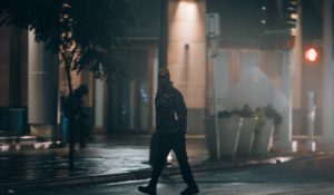 man in jacket walking at night (stock image)