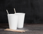 two white paper cups with wooden stir sticks