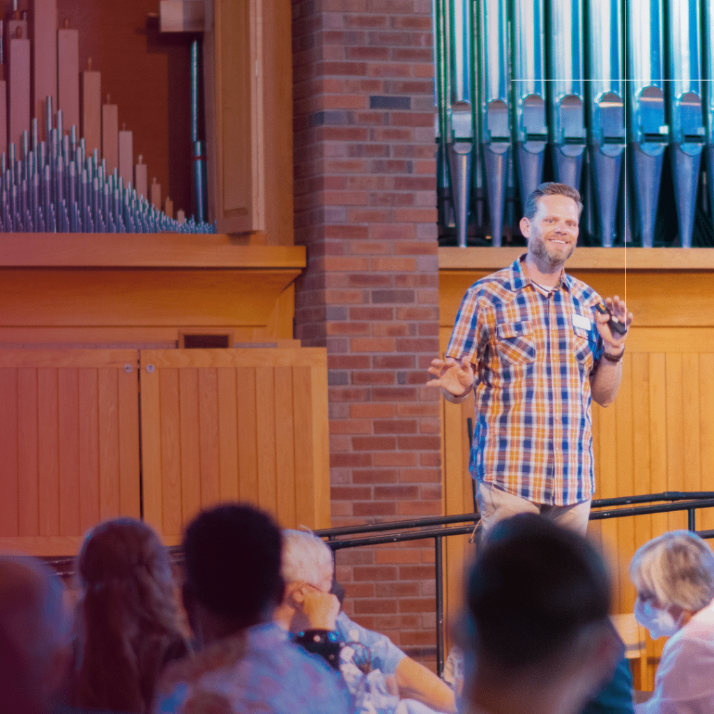 Jeremy Myers in front of a group of people in the chapel teaching. 