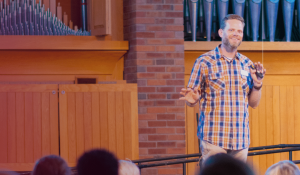 Jeremy Myers in front of a group of people in the chapel teaching.