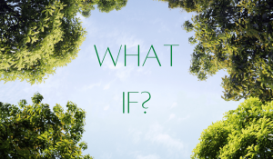 "What if?" in the middle of a blue sky with trees around it. Perspective taken from the ground looking up.